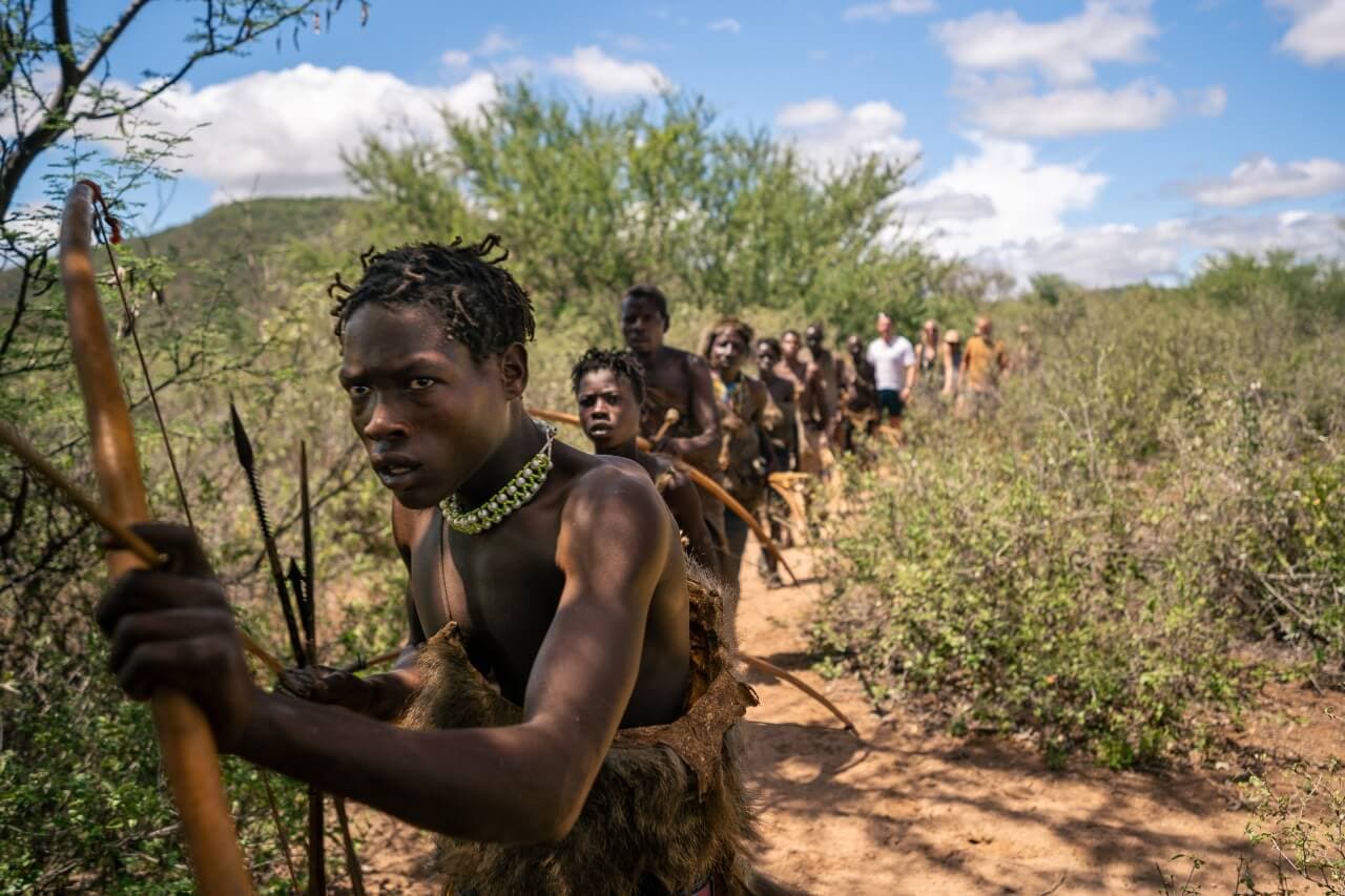 Hadzabe hunter with a handmade bow at dawn